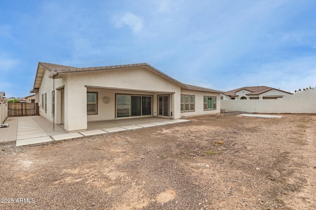 13850 W Weaver Ct, Litchfield Park, AZ 85340 - rear view of property featuring a fenced backyard, stucco siding, and a patio