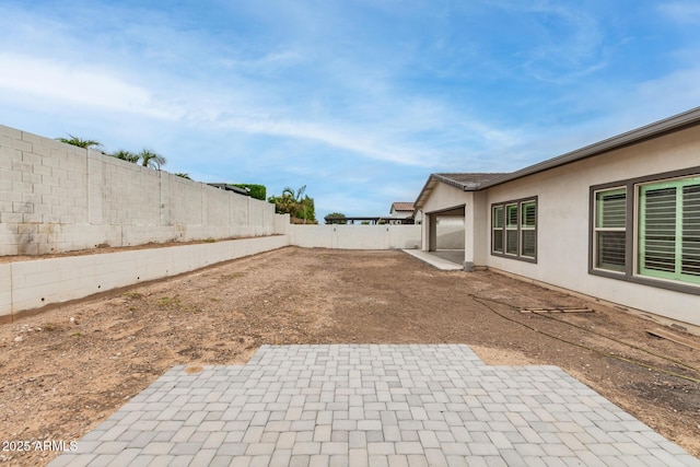 13850 W Weaver Ct, Litchfield Park, AZ 85340 - fenced backyard with a patio area and a garage