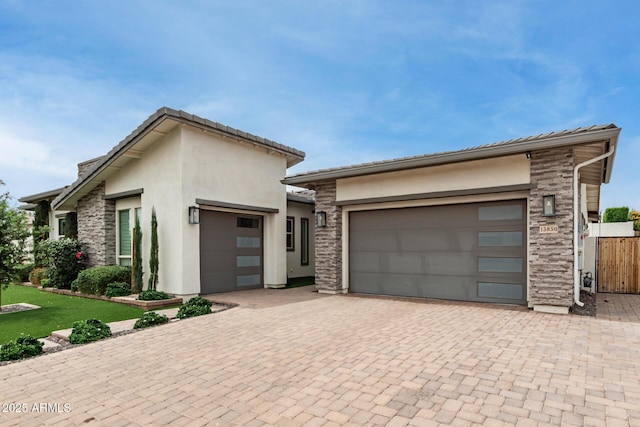 13850 W Weaver Ct, Litchfield Park, AZ 85340 - view of front of property with an attached garage, stucco siding, decorative driveway, and stone siding