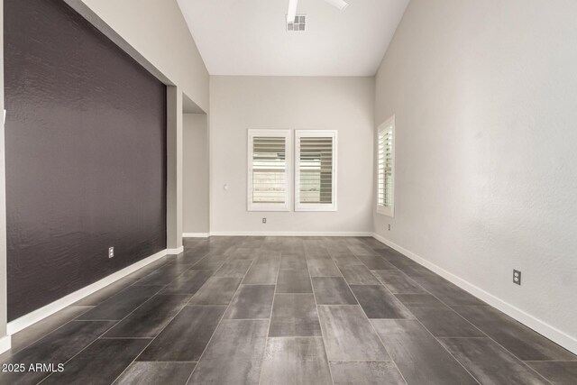 13850 W Weaver Ct, Litchfield Park, AZ 85340 - empty room featuring dark wood-style flooring and baseboards