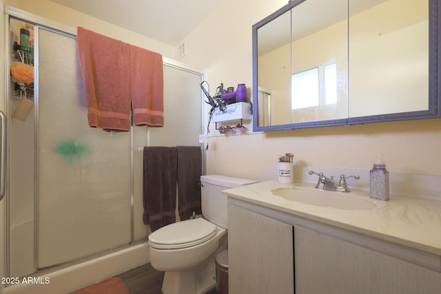 bathroom with hardwood / wood-style flooring, vanity, toilet, and walk in shower