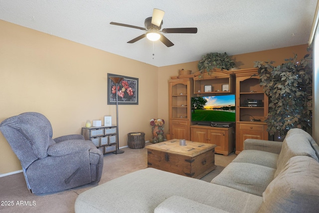 living room with ceiling fan, light carpet, and a textured ceiling