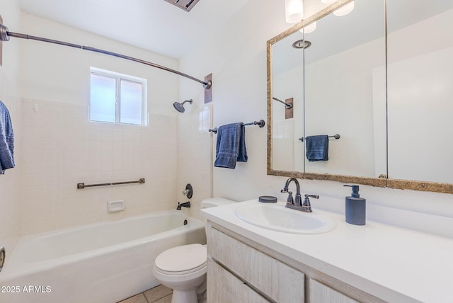 full bathroom featuring toilet, vanity, tile patterned floors, and tiled shower / bath