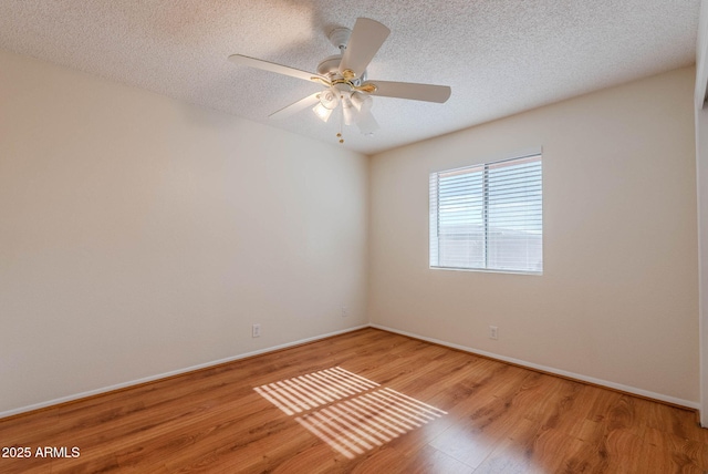 empty room featuring ceiling fan, a textured ceiling, and hardwood / wood-style floors