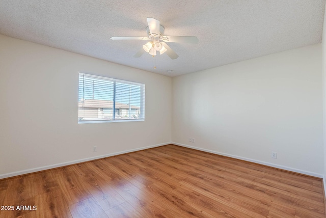 spare room with a textured ceiling, ceiling fan, and light hardwood / wood-style floors