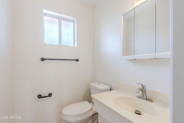 bathroom featuring toilet and vanity