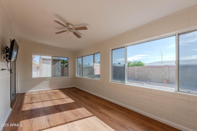 unfurnished sunroom featuring ceiling fan and vaulted ceiling