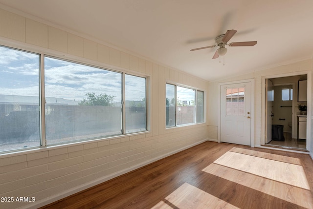 unfurnished sunroom featuring ceiling fan and lofted ceiling