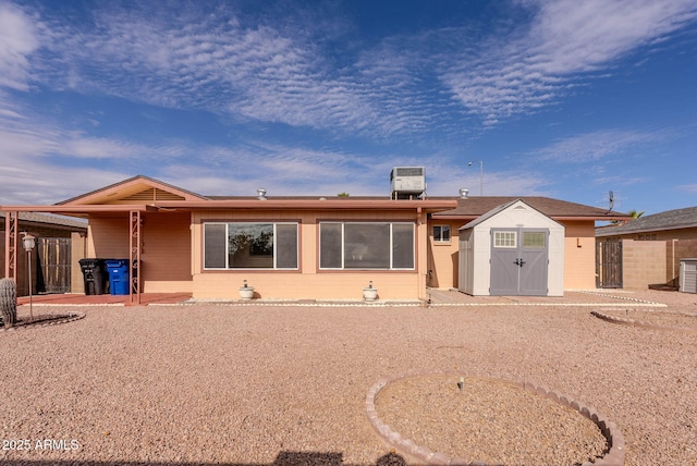 back of property featuring central AC unit, a patio area, and a storage shed