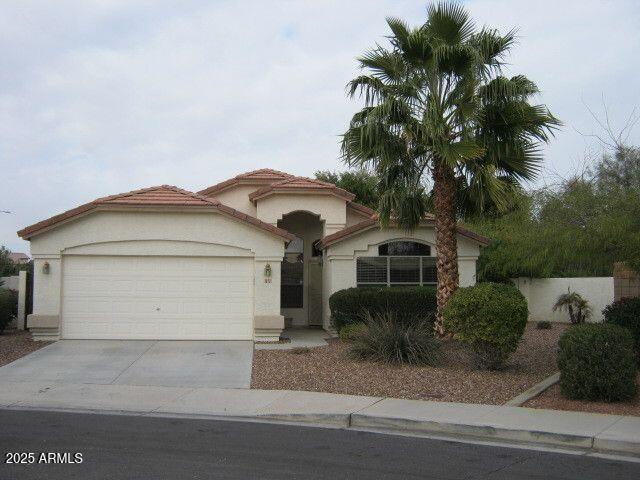 view of front of home featuring a garage, concrete driveway, and stucco siding