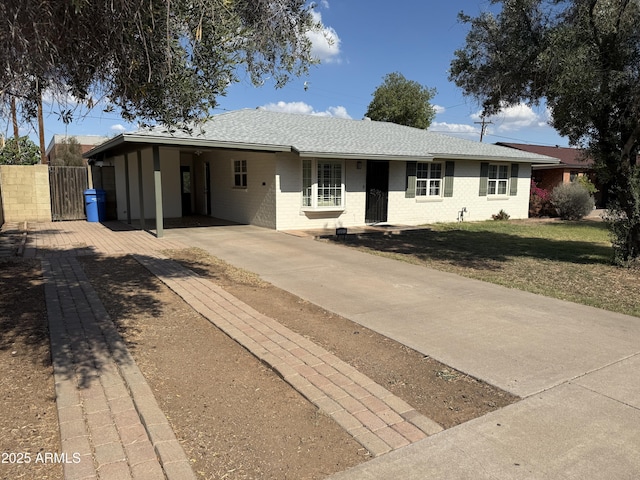 3001 N 21st Ave, Phoenix, AZ 85015 - ranch-style home with concrete driveway, an attached carport, roof with shingles, and a gate