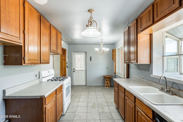 3001 N 21st Ave, Phoenix, AZ 85015 - kitchen with white gas range, a sink, a chandelier, and light countertops