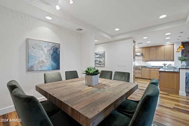 dining space featuring light hardwood / wood-style floors and sink