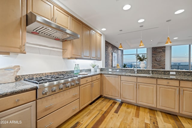 kitchen with stainless steel gas cooktop, sink, light brown cabinets, light hardwood / wood-style flooring, and hanging light fixtures