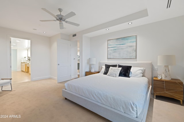 carpeted bedroom featuring ensuite bathroom and ceiling fan