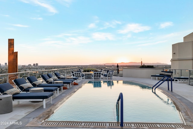 view of pool at dusk