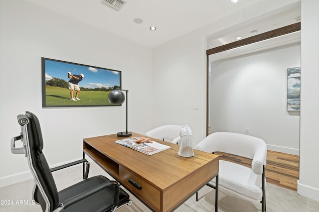 office area with beam ceiling and light hardwood / wood-style floors