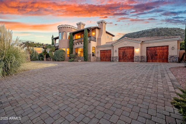 view of front of home with a garage and a balcony