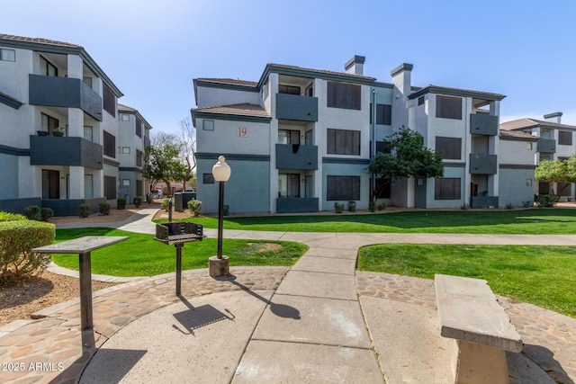 view of community with a residential view and a yard