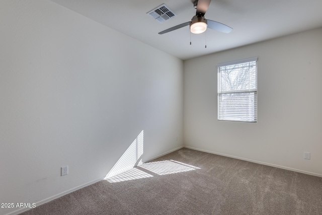 empty room with a ceiling fan, baseboards, visible vents, and carpet flooring