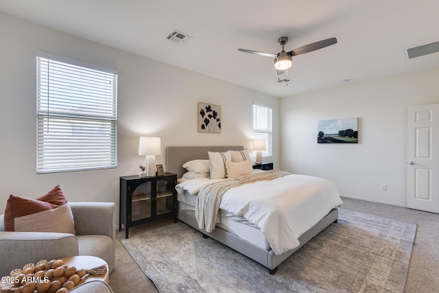 bedroom with carpet floors, visible vents, baseboards, and a ceiling fan