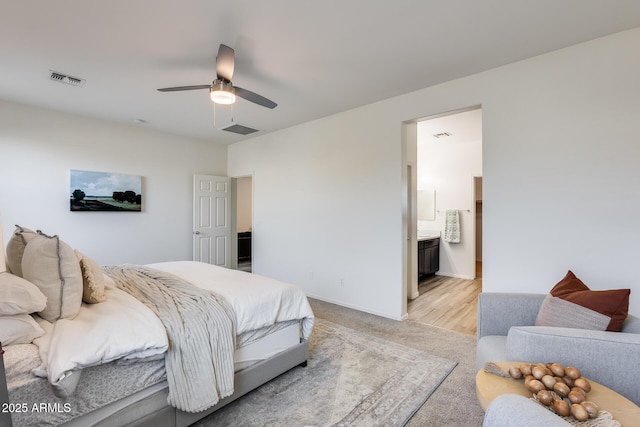 bedroom featuring connected bathroom, visible vents, and ceiling fan