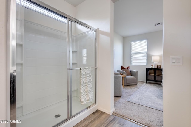 full bath featuring a stall shower, wood finished floors, and visible vents