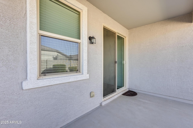 view of exterior entry with stucco siding