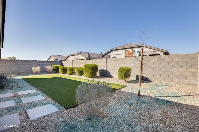 view of yard with a fenced backyard