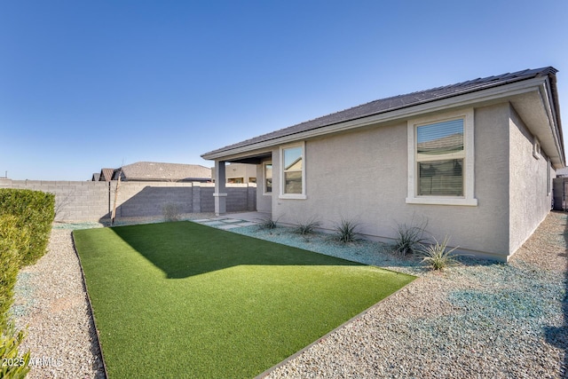 exterior space with central AC unit and a fenced backyard