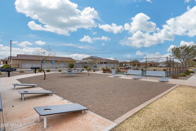 view of property's community with a residential view and fence