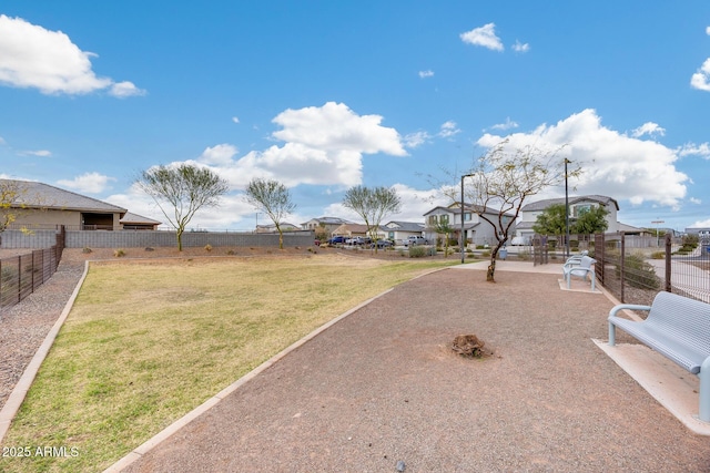 view of yard featuring a residential view and fence