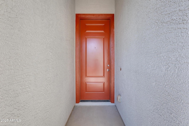 property entrance with stucco siding