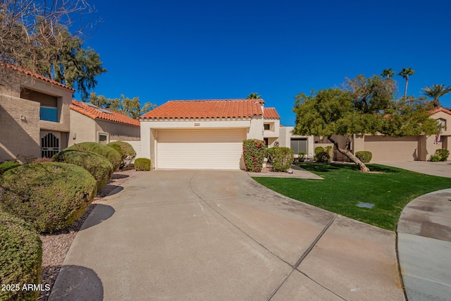 mediterranean / spanish home featuring a front lawn