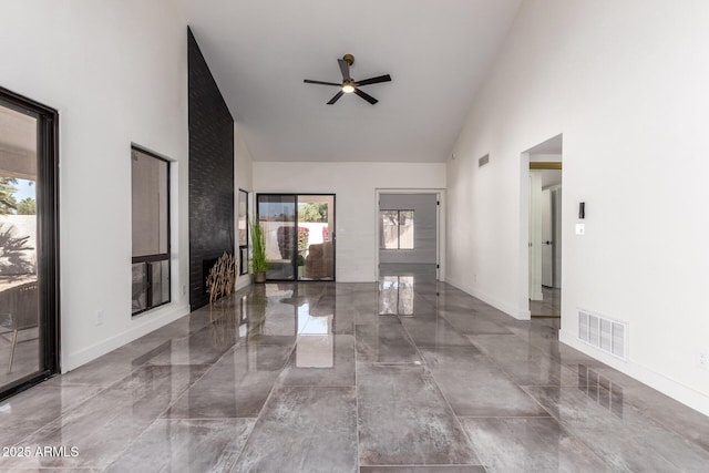 interior space with ceiling fan, high vaulted ceiling, and plenty of natural light