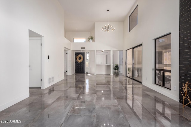 foyer with a chandelier and a towering ceiling