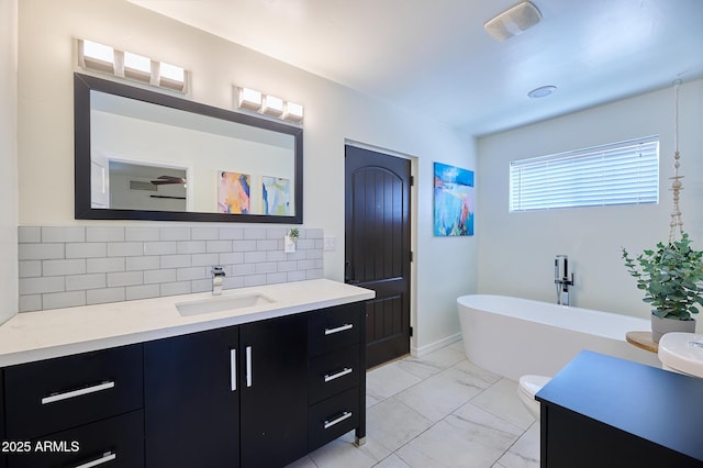 bathroom with marble finish floor, a soaking tub, visible vents, decorative backsplash, and vanity