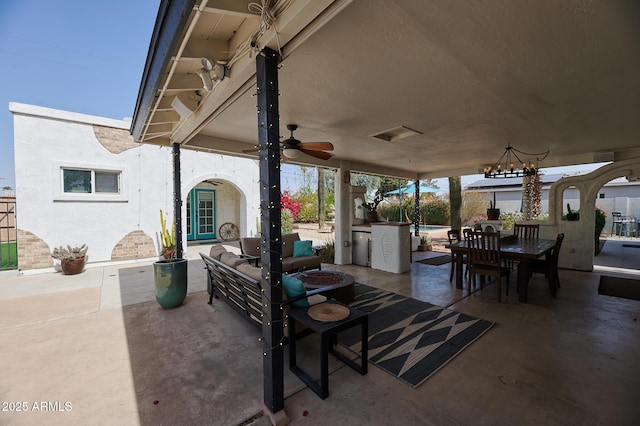 view of patio / terrace with ceiling fan, outdoor dining area, visible vents, and an outdoor pool