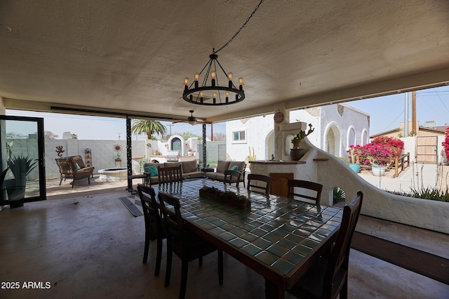 sunroom / solarium featuring a notable chandelier