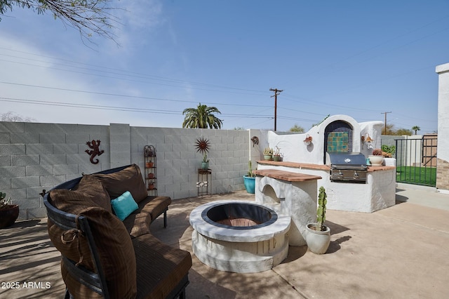 view of patio / terrace with an outdoor fire pit, a fenced backyard, and area for grilling