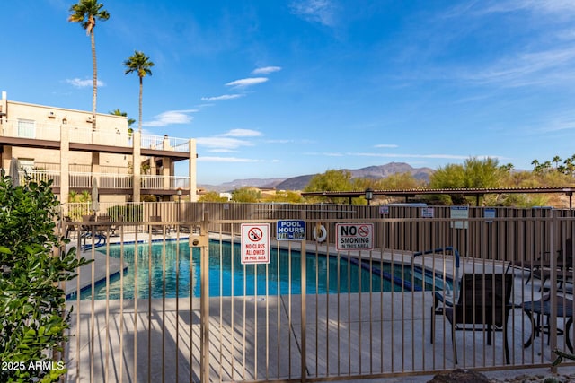 view of swimming pool featuring a mountain view