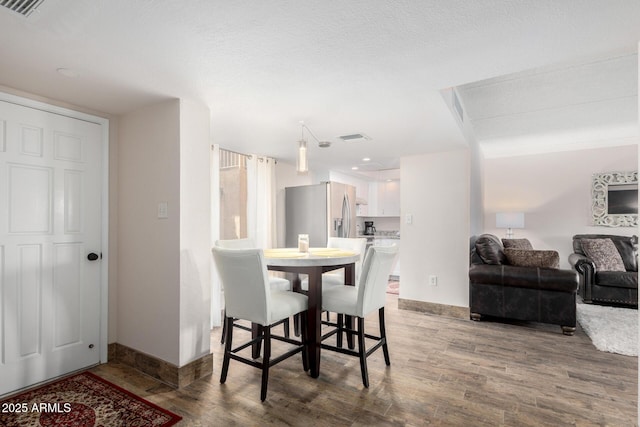 dining room with hardwood / wood-style flooring