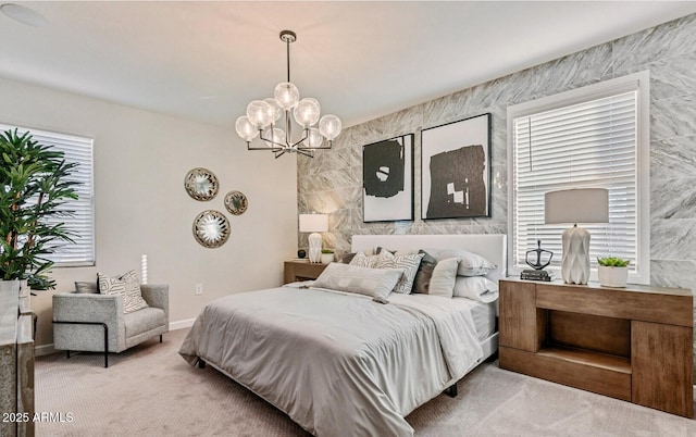 carpeted bedroom with baseboards and a chandelier