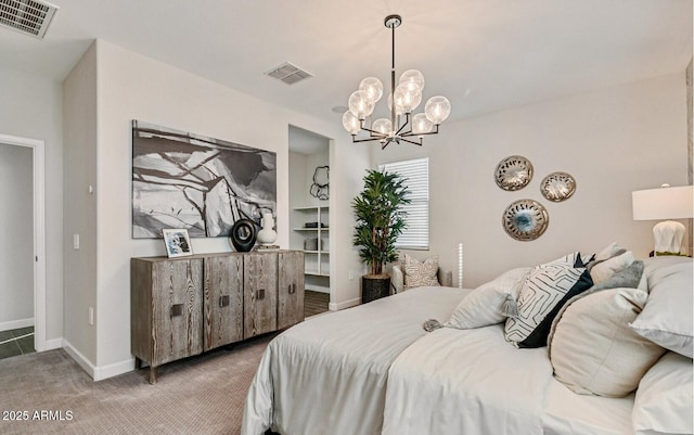 bedroom featuring carpet floors, baseboards, visible vents, and an inviting chandelier