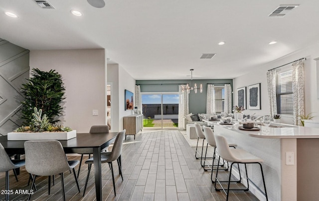 dining space featuring recessed lighting, dark wood-style floors, a chandelier, and visible vents