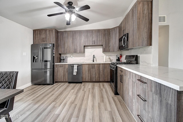 kitchen with tasteful backsplash, visible vents, appliances with stainless steel finishes, light wood-type flooring, and a sink