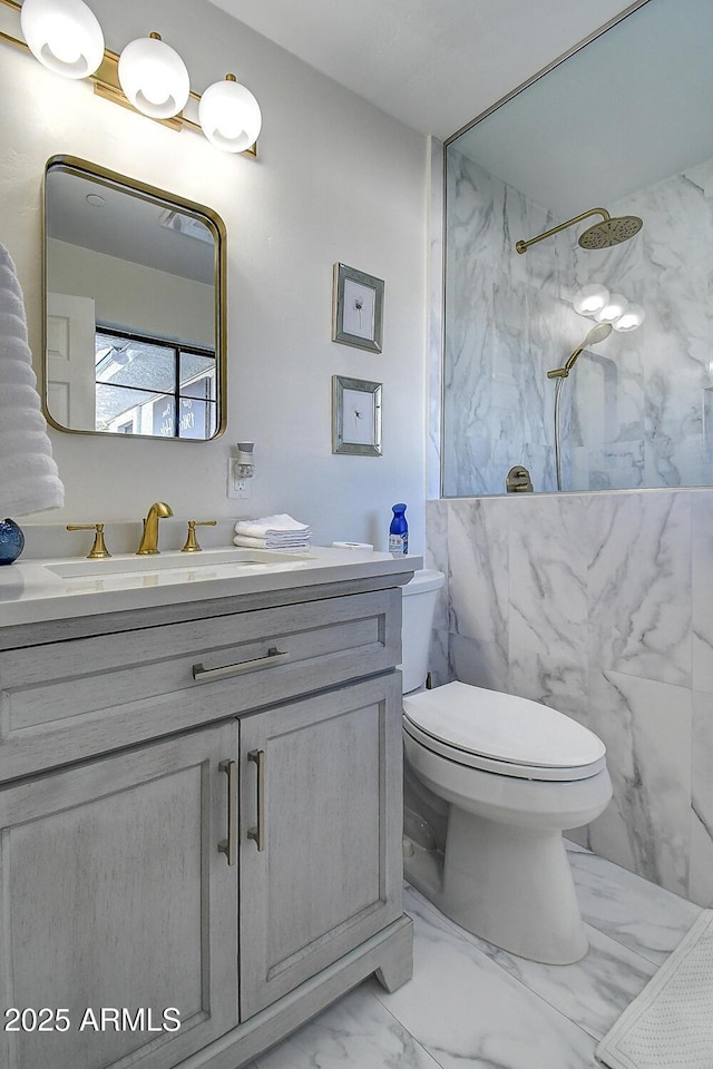 full bath featuring marble finish floor, toilet, vanity, and a marble finish shower