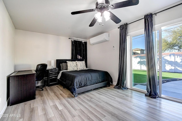 bedroom with access to outside, a wall mounted AC, light wood-style flooring, and a ceiling fan