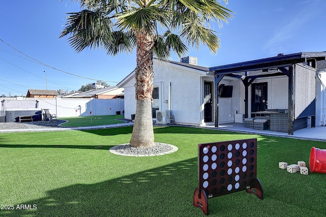 view of front facade with a front yard, a patio area, and fence