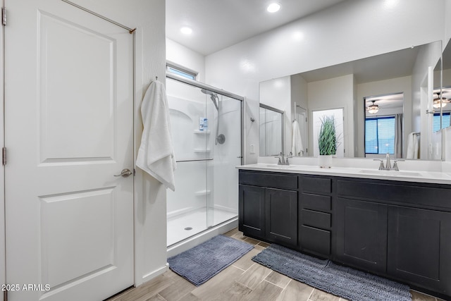 bathroom featuring vanity and a shower with shower door